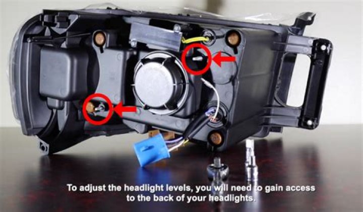 How do you adjust the headlights on a Vauxhall Vectra?