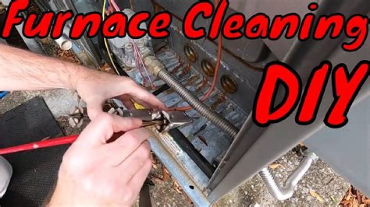 How do you clean the gas burner on a Dometic refrigerator?