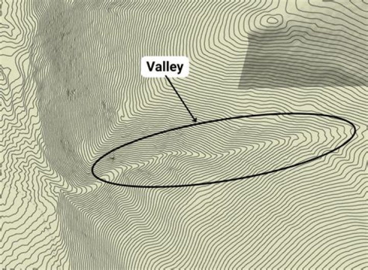 How do you identify a valley on a contour map