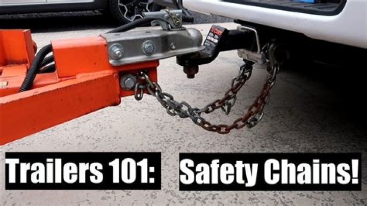 How should you ensure that safety chains are attached to the trailer?